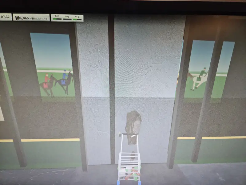 The betting parlor entrance with race pictures behind the windows on both sides and a gray wall where the door should be